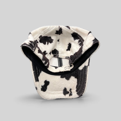 Raree Finds BULA black and white cow print plush fleece cap with an unstructured crown and curved brim