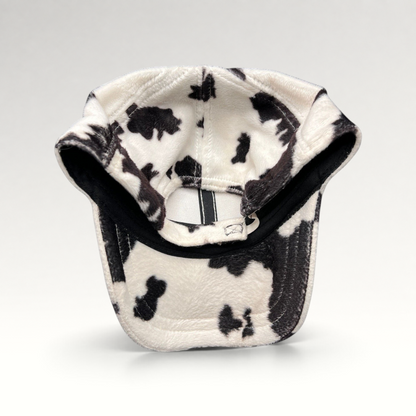 Raree Finds BULA black and white cow print plush fleece cap with an unstructured crown and curved brim