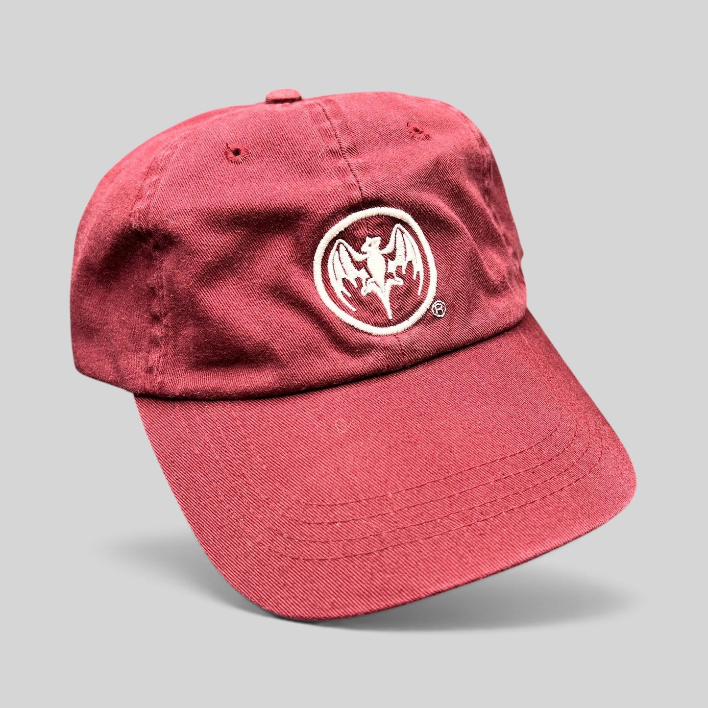 Raree Finds burgundy cotton strapback hat featuring an embroidered white Bacardi bat logo on the front crown.