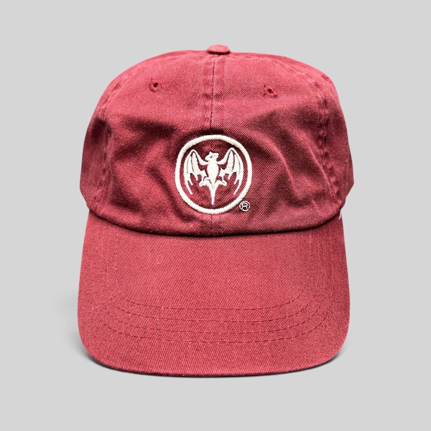 Raree Finds burgundy cotton strapback hat featuring an embroidered white Bacardi bat logo on the front crown