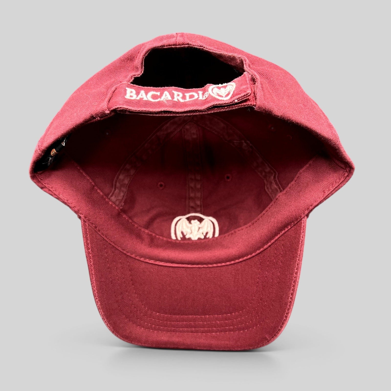 Raree Finds burgundy cotton strapback hat with embroidered Bacardi bat logo and rear strap branding