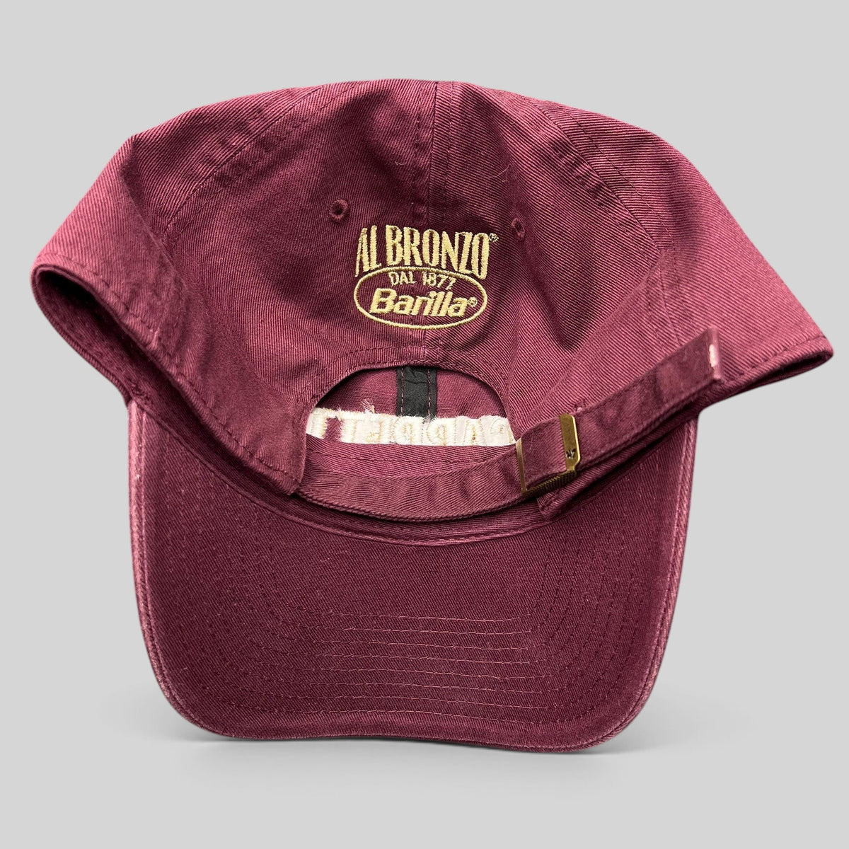 Raree Finds burgundy strapback hat with gold Al Bronzo Barilla embroidery on the back and adjustable metal buckle