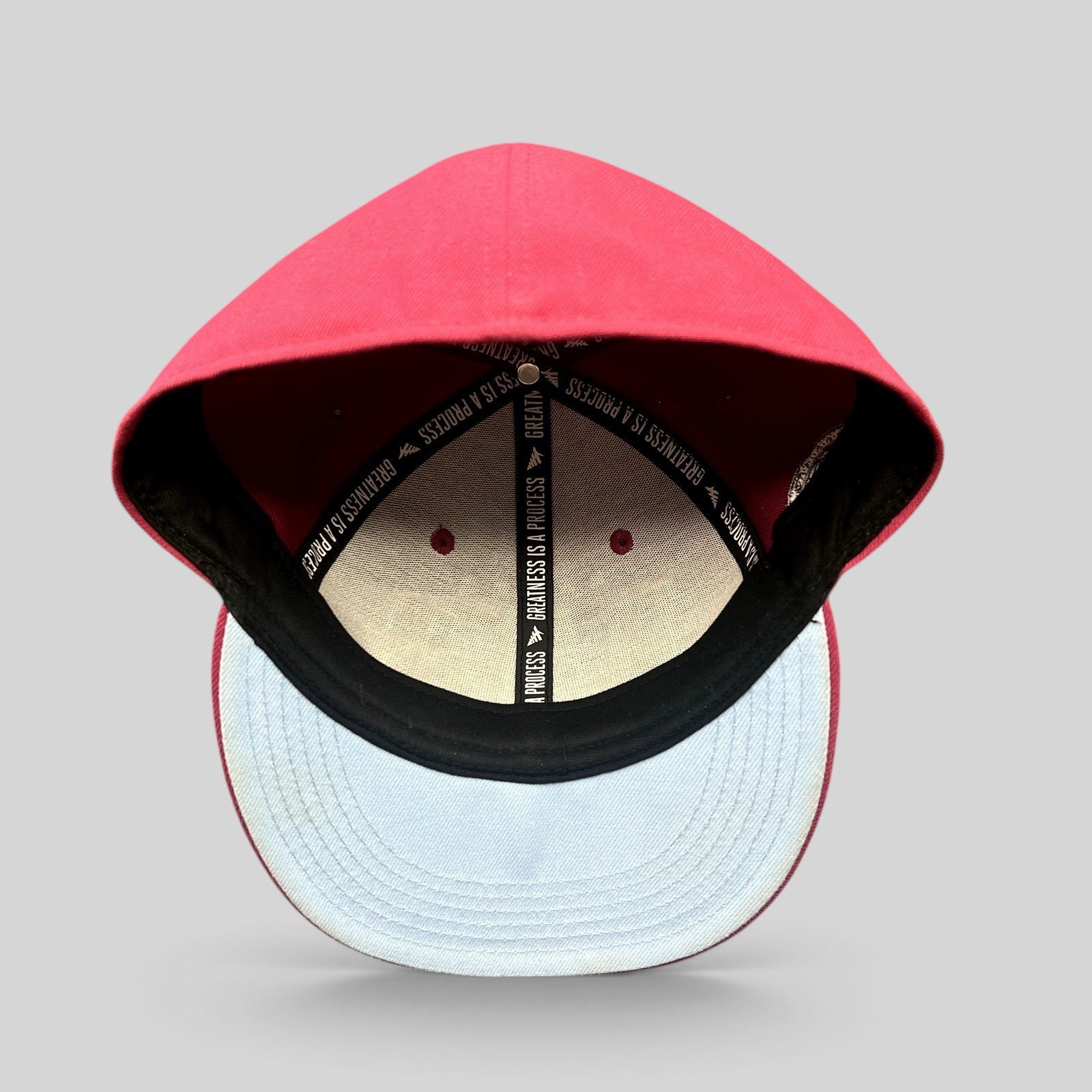 Raree Finds burgundy Paper Planes fitted hat interior showing signature Greatness Is A Process motivational taping
