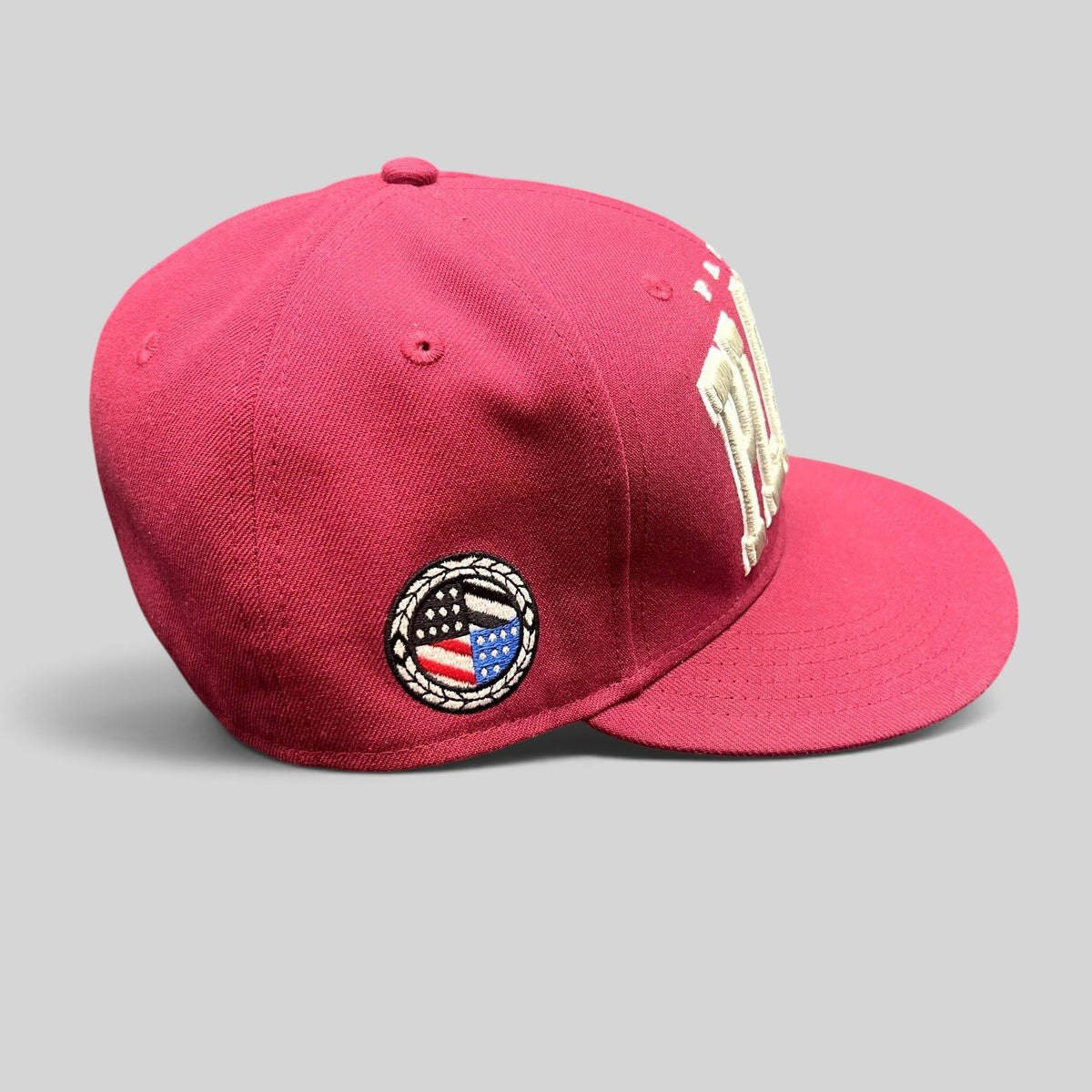 Raree Finds burgundy Paper Planes fitted hat with raised white embroidery and circular side patch detail