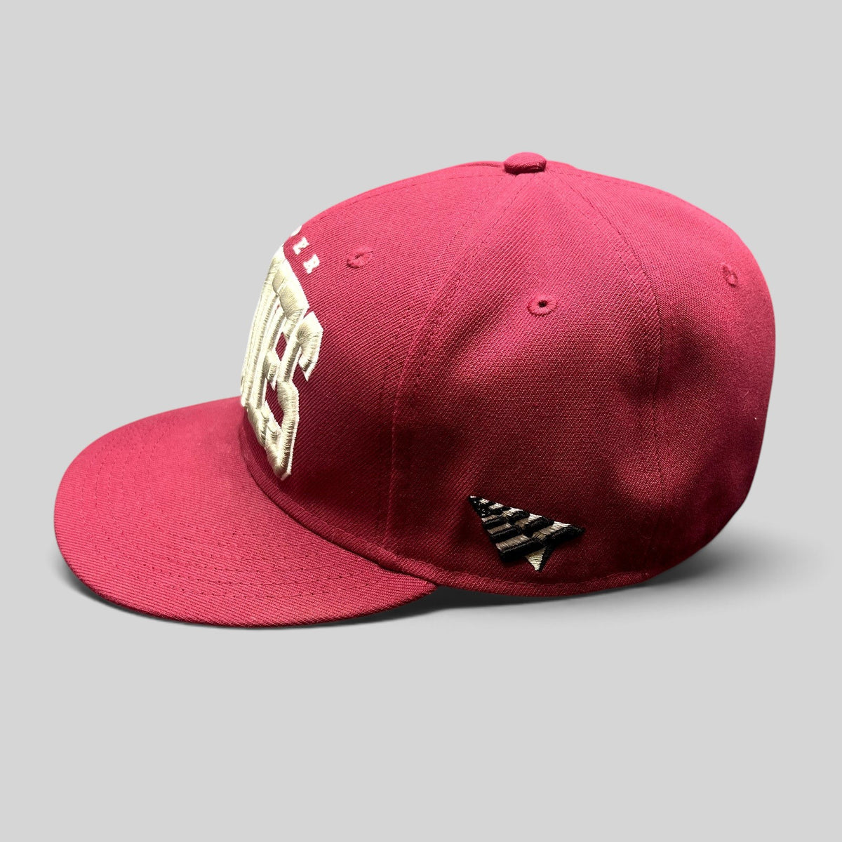 Raree Finds burgundy Paper Planes fitted hat with raised white PLANES embroidery and side paper plane logo patch
