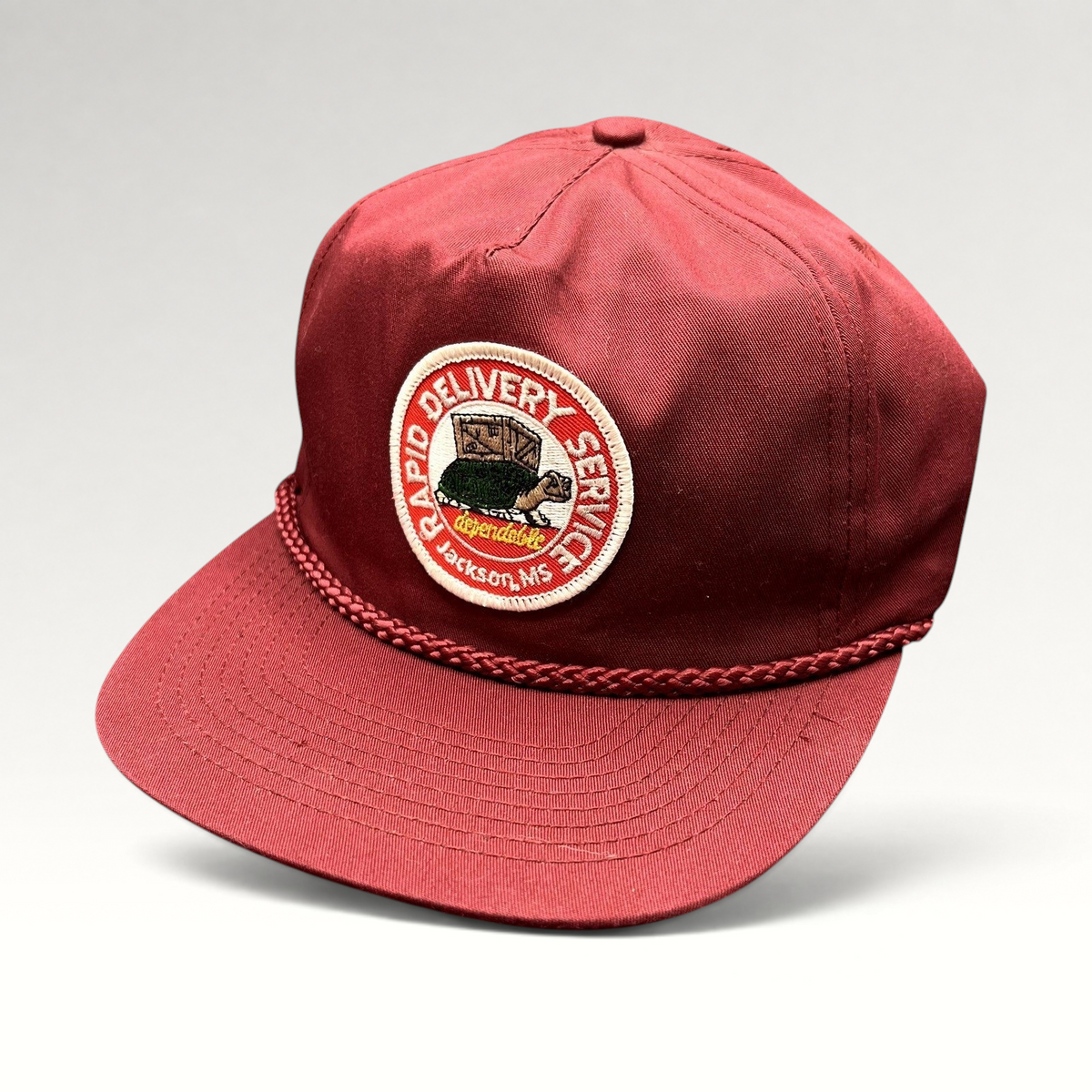 Raree Finds vintage burgundy snapback trucker hat with braided rope brim and Rapid Delivery Service patch