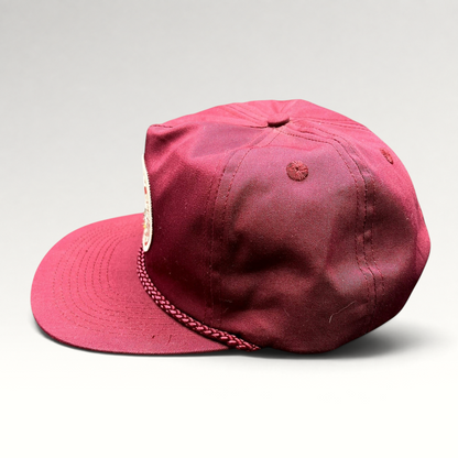 Raree Finds vintage burgundy trucker hat with braided rope detail and Rapid Delivery Service patch, side profile view.