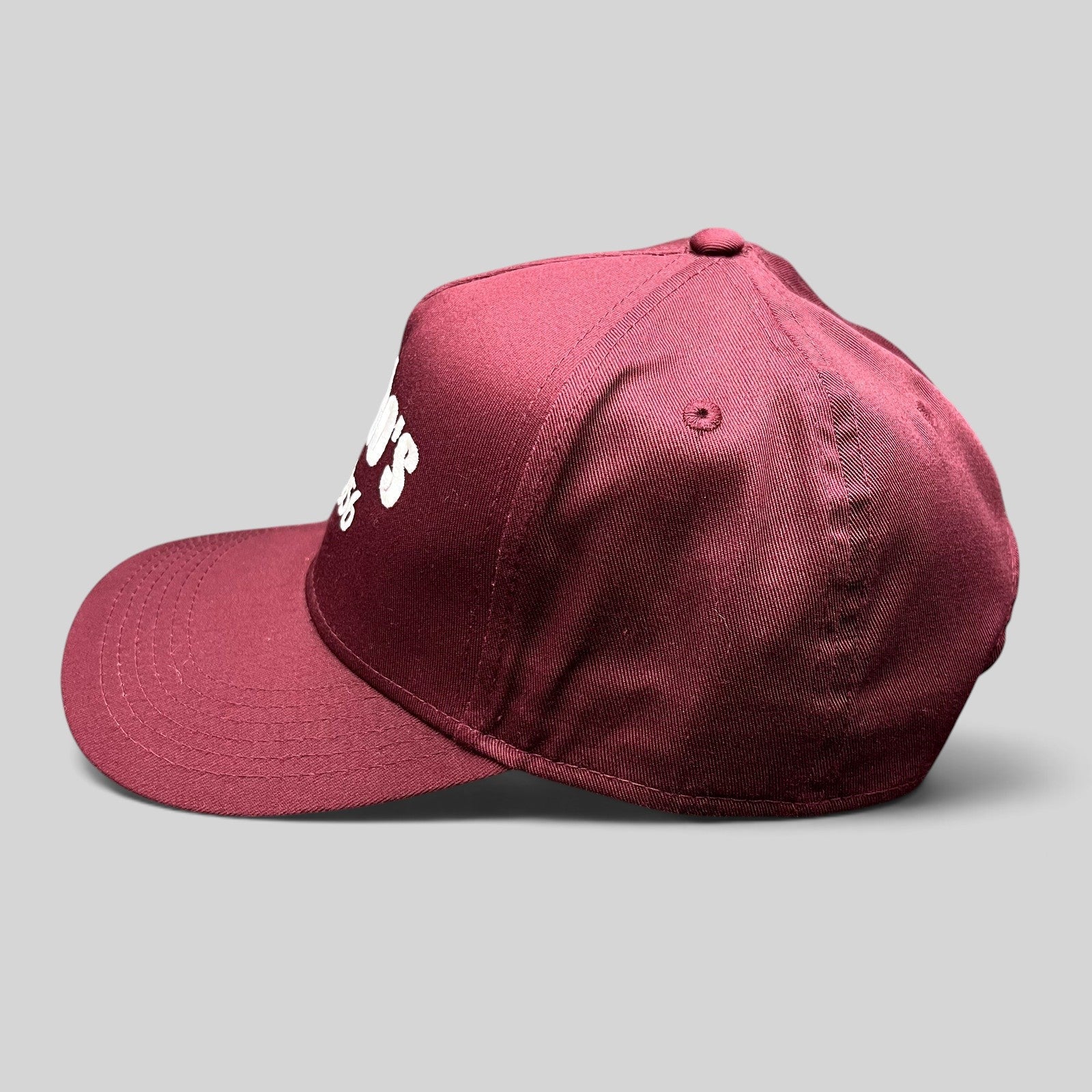 Raree Finds burgundy Otto Cap snapback hat with white Santoro’s Since 1956 embroidery, side profile view.