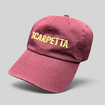 Raree Finds burgundy strapback hat with Scarpetta embroidered in gold lettering on the front crown