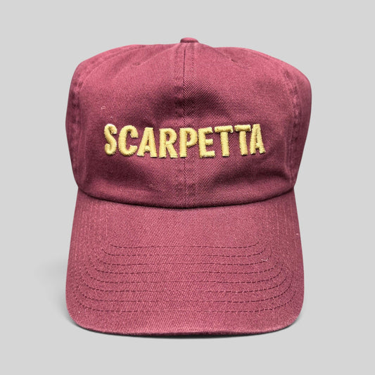 Raree Finds burgundy strapback hat with Scarpetta embroidered in gold lettering on the front crown