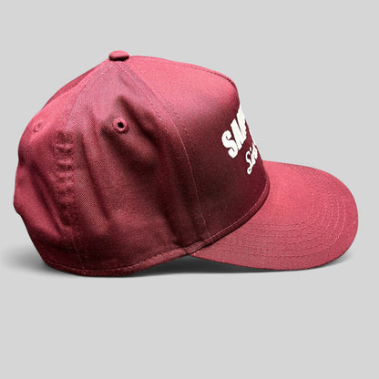 Raree Finds burgundy Otto Cap snapback hat with white Santoro’s Since 1956 embroidery and a flat brim profile.