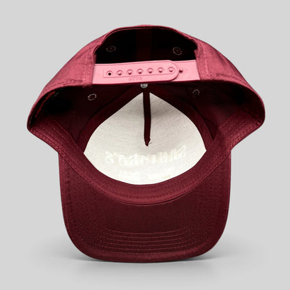 Raree Finds burgundy Otto Cap snapback hat showing the interior view with adjustable plastic snap closure