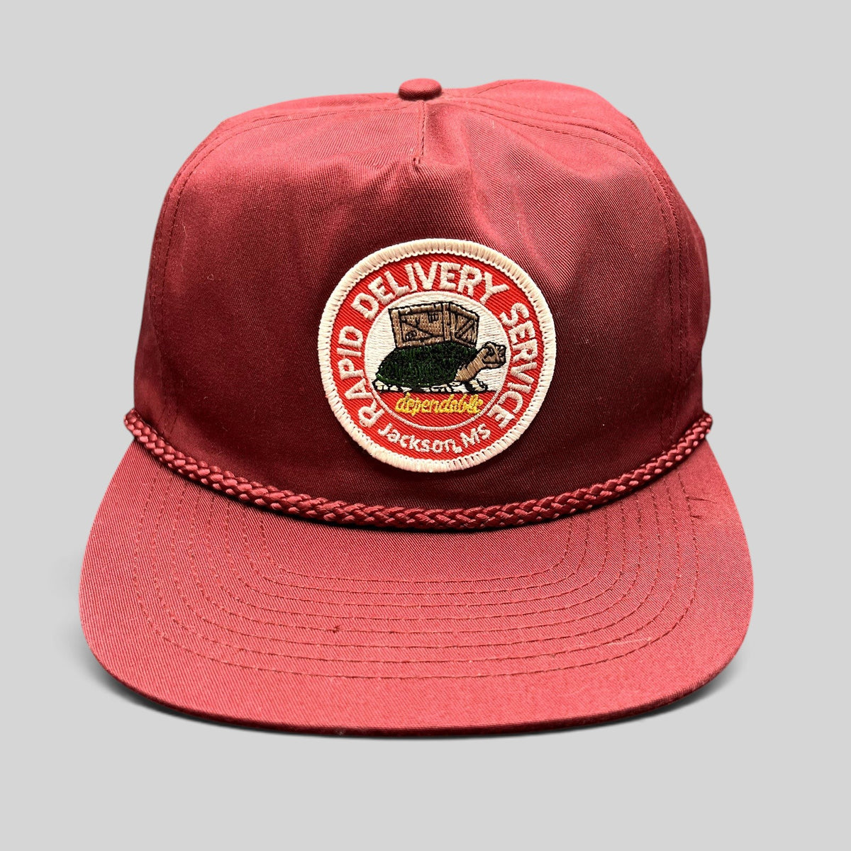 Raree Finds vintage burgundy trucker hat with braided rope brim and Rapid Delivery Service embroidered patch