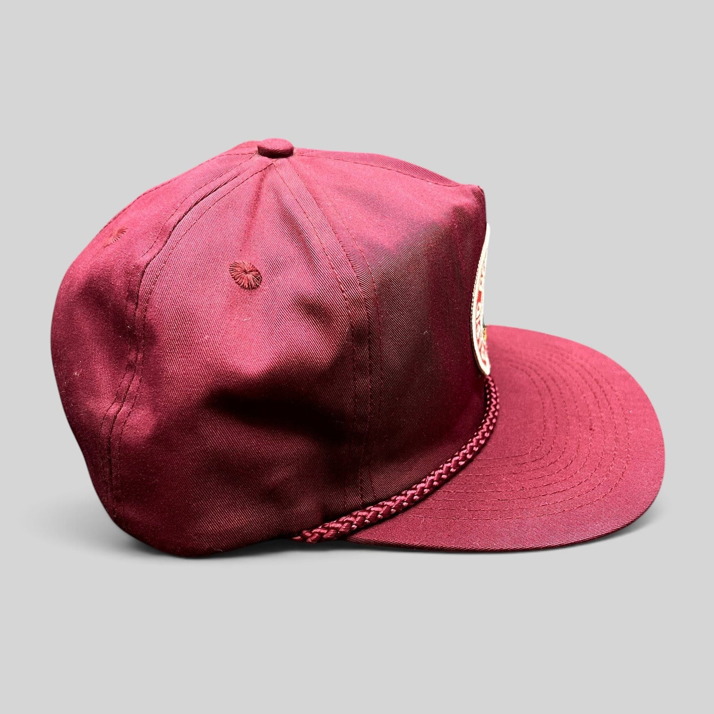 Raree Finds vintage burgundy trucker hat with braided rope detail and Rapid Delivery Service patch