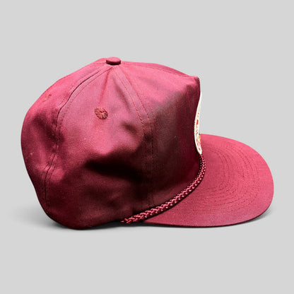 Raree Finds vintage burgundy trucker hat with braided rope detail and Rapid Delivery Service patch