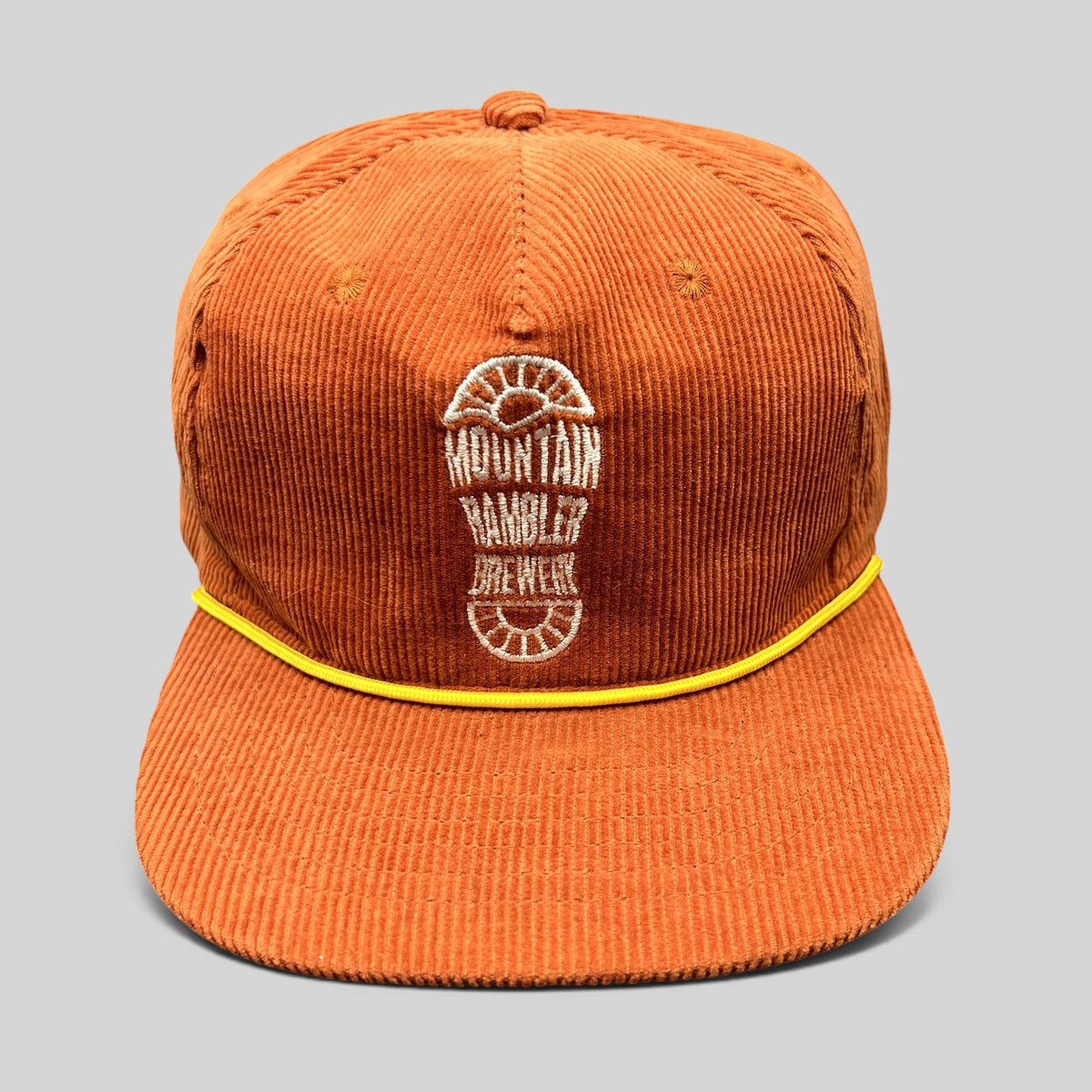 Raree Finds burnt orange corduroy snapback hat with yellow rope trim and Mountain Rambler Brewery boot-print logo.