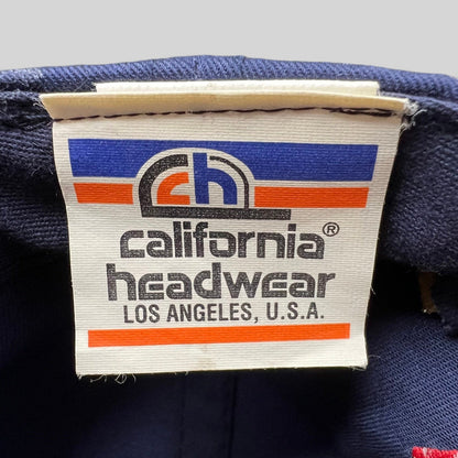 Raree Finds vintage California Headwear clothing tag on a navy blue UCLA 1995 National Champions snapback hat
