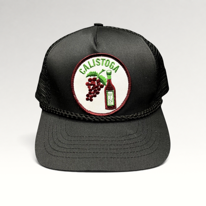 Raree Finds vintage black Calistoga Wine trucker hat with embroidered grape and wine bottle patch and braided rope