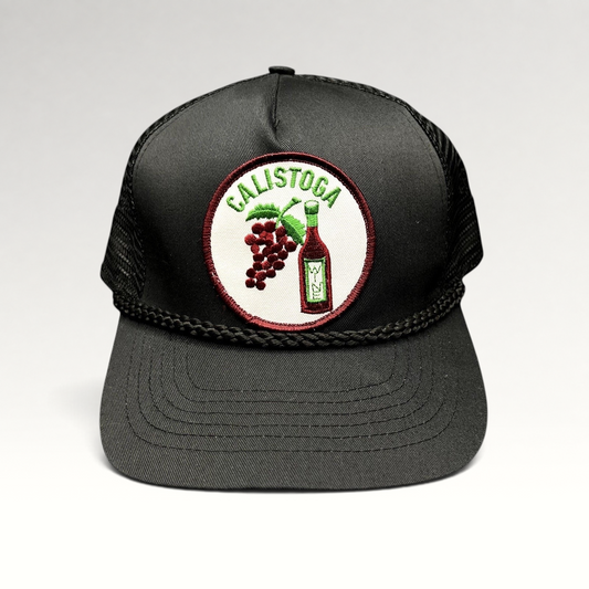 Raree Finds vintage black Calistoga Wine trucker hat with embroidered grape and wine bottle patch and braided rope
