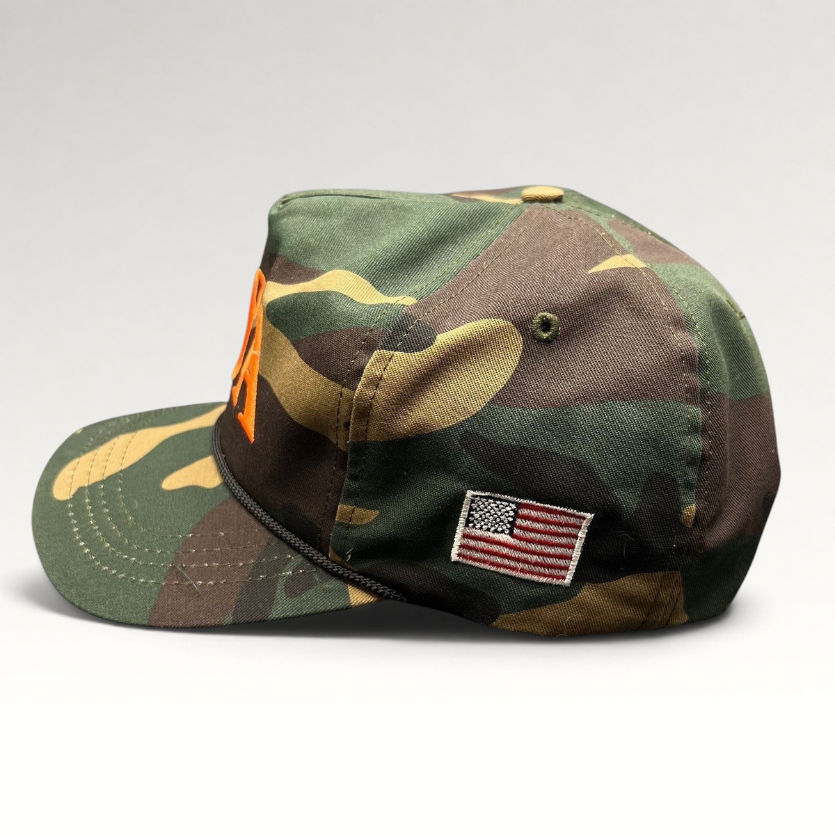 Raree Finds woodland camo snapback hat with orange USA embroidery, black rope detail, and side American flag patch.
