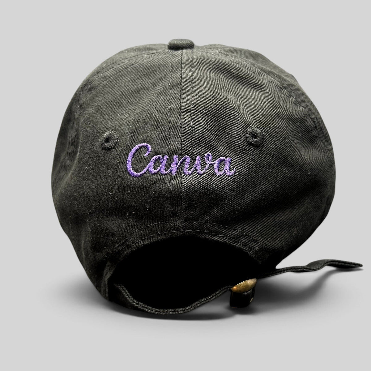 Raree Finds black cotton twill dad cap with purple embroidered Canva logo on the back and adjustable brass buckle