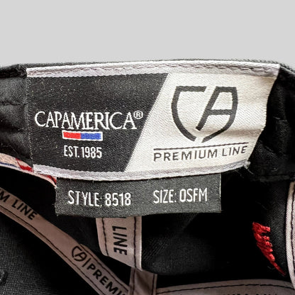 Raree Finds Cap America Premium Line interior tag showing style 8518 and OSFM size on a black racing snapback hat