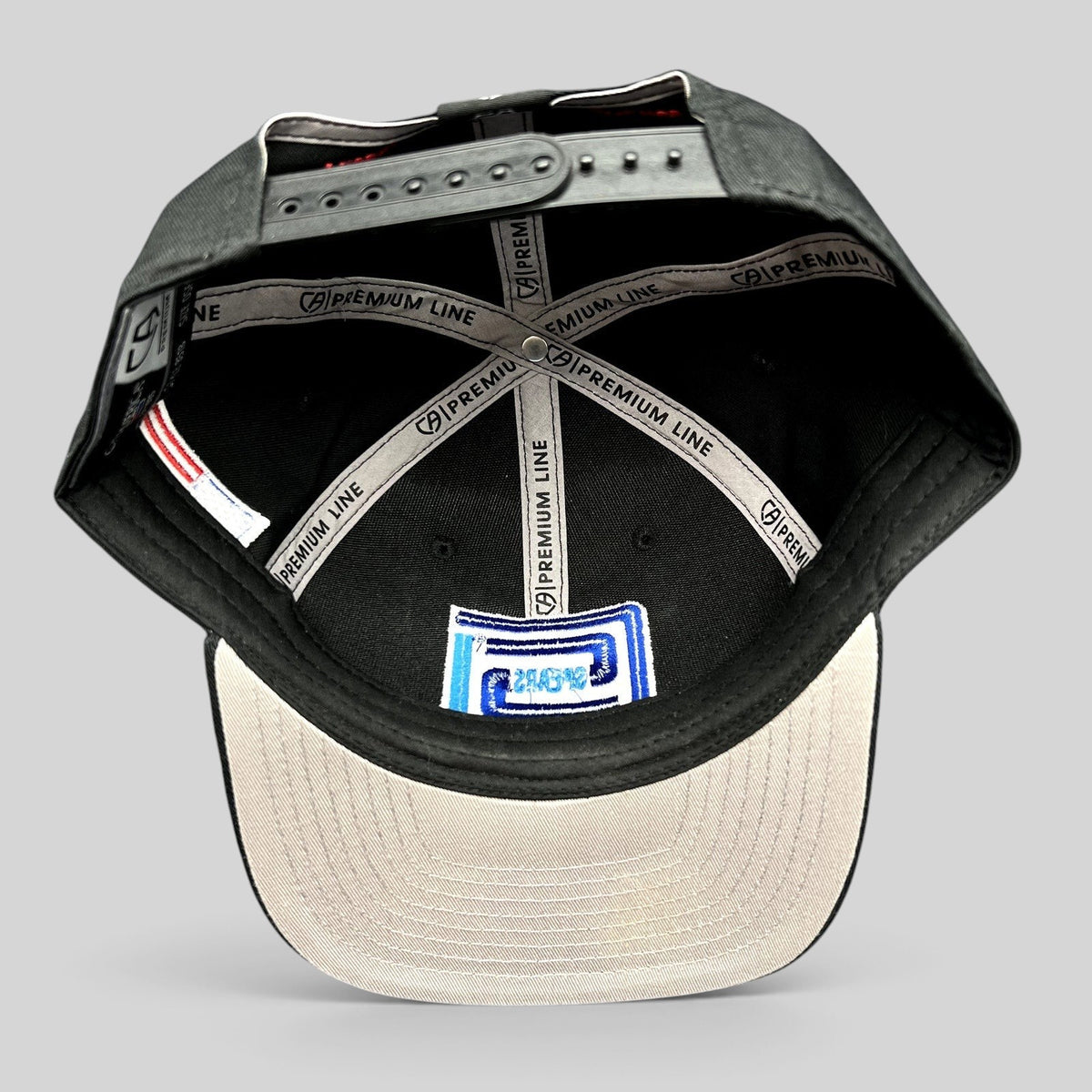 Raree Finds Cap America Premium Line black snapback hat interior showing branded taping and gray undervisor