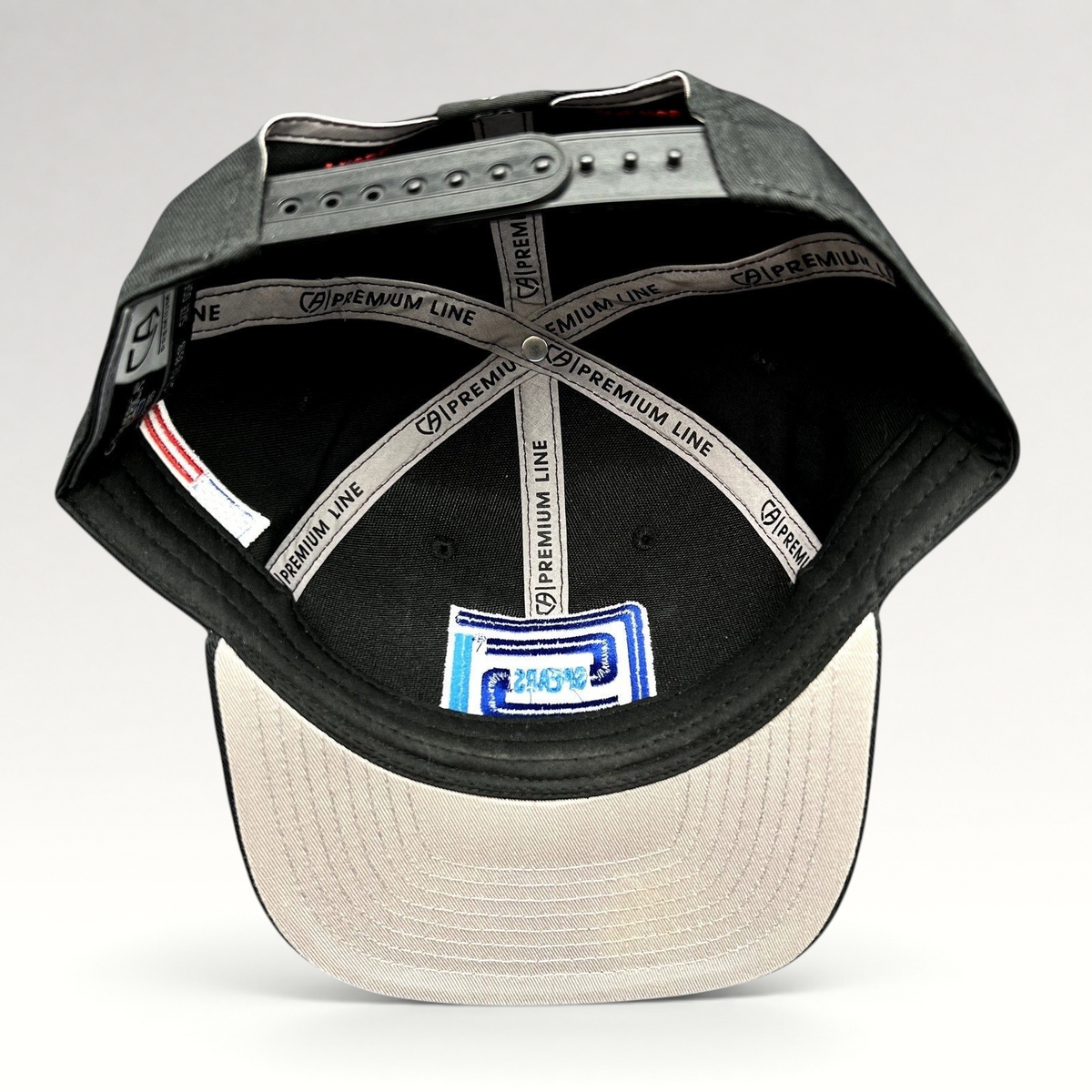 Raree Finds Cap America Premium Line black snapback hat interior showing branded taping and gray undervisor
