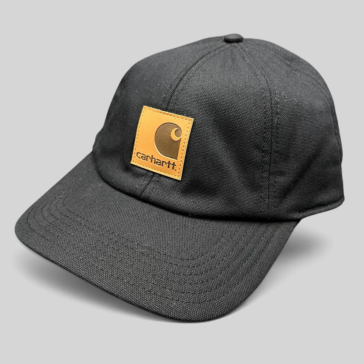 Raree Finds Carhartt black duck canvas workwear cap with a tan square logo patch on the front crown