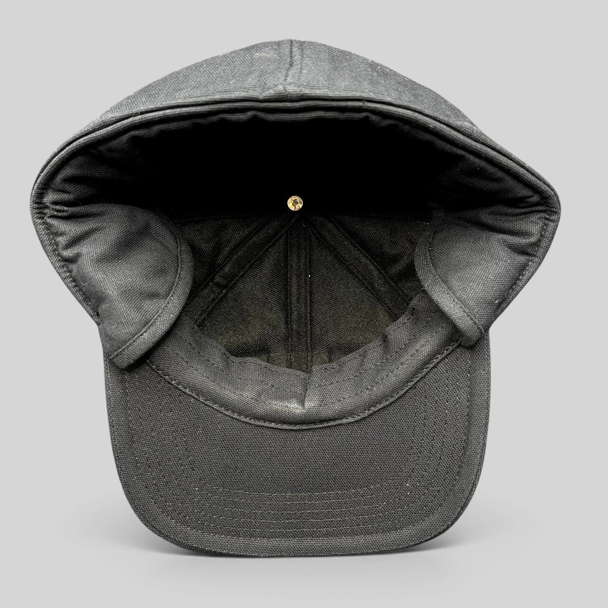 Raree Finds black Carhartt duck canvas workwear cap with fold-down ear warmers shown from the interior view.