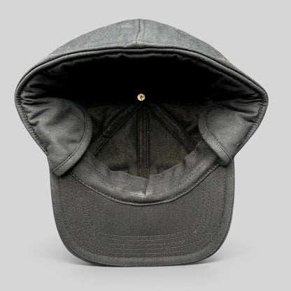 Raree Finds black Carhartt duck canvas workwear cap with fold-down ear warmers shown from the interior view.