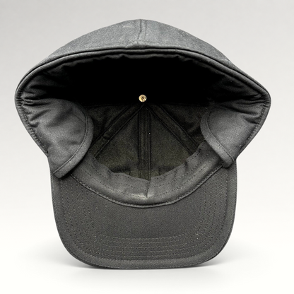 Raree Finds black Carhartt duck canvas workwear cap with fold-down ear warmers shown from the interior view.