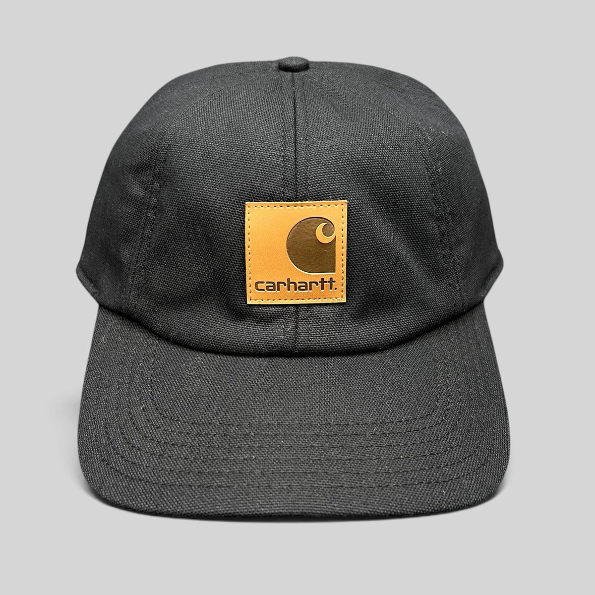 Raree Finds Carhartt black duck canvas workwear cap with a square logo patch and fold-down ear warmers.