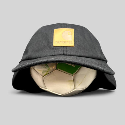 Raree Finds black Carhartt duck canvas ear flap cap with a tan square logo patch on the front