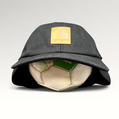 Raree Finds black Carhartt duck canvas ear flap cap with a tan square logo patch on the front