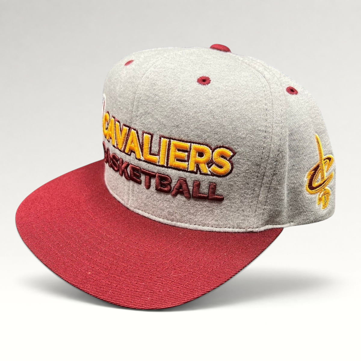 Raree Finds Mitchell & Ness Cleveland Cavaliers snapback hat in heather gray with a wine red brim and gold embroidery.