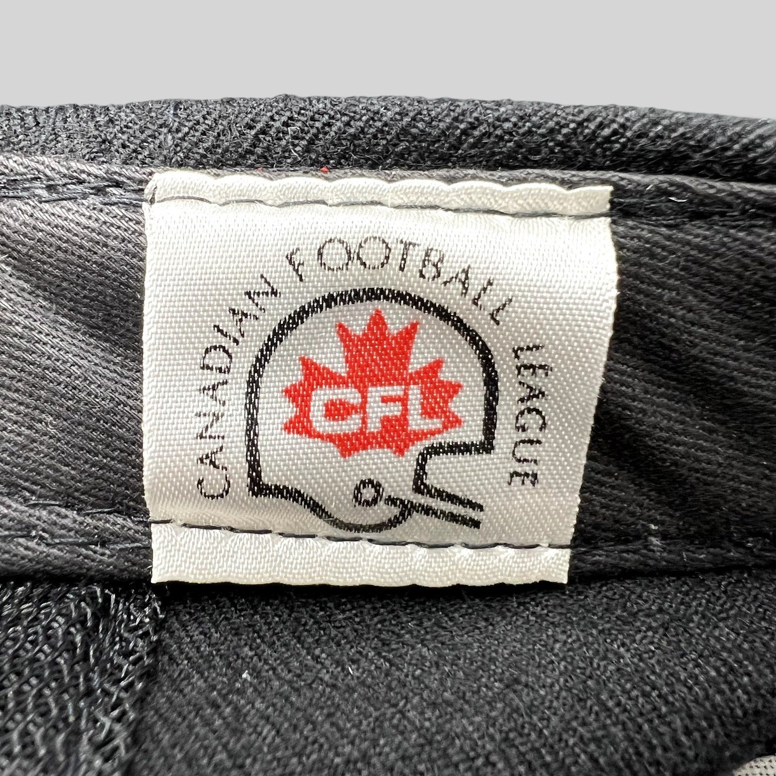 Raree Finds vintage Birmingham Barracudas CFL hat interior tag with Canadian Football League logo and helmet graphic