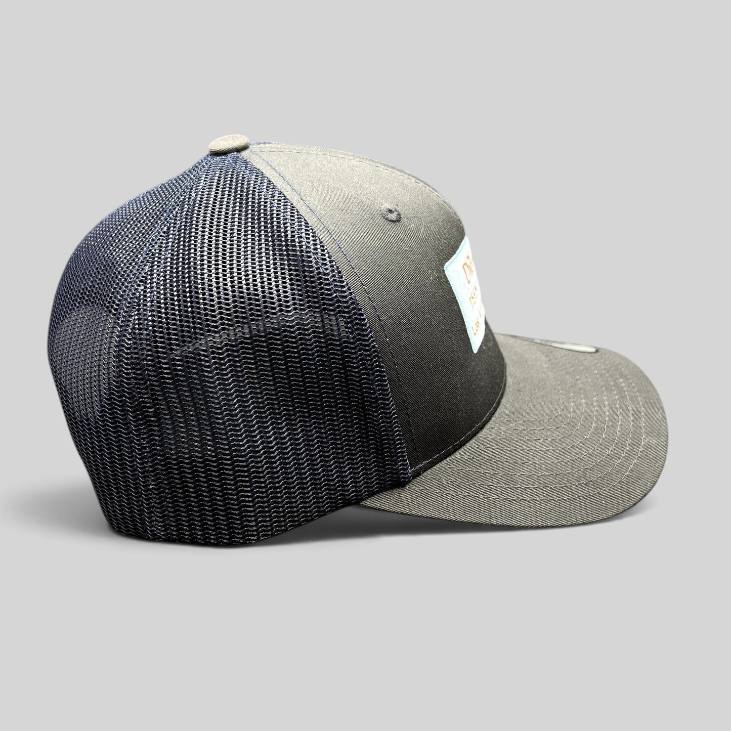 Raree Finds Diller Teen Fellows Yupoong Classics trucker hat in charcoal and navy with embroidered patch side view