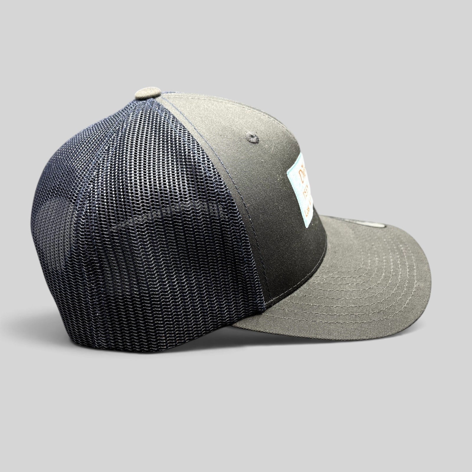 Raree Finds Diller Teen Fellows Yupoong Classics trucker hat in charcoal and navy with embroidered patch side view
