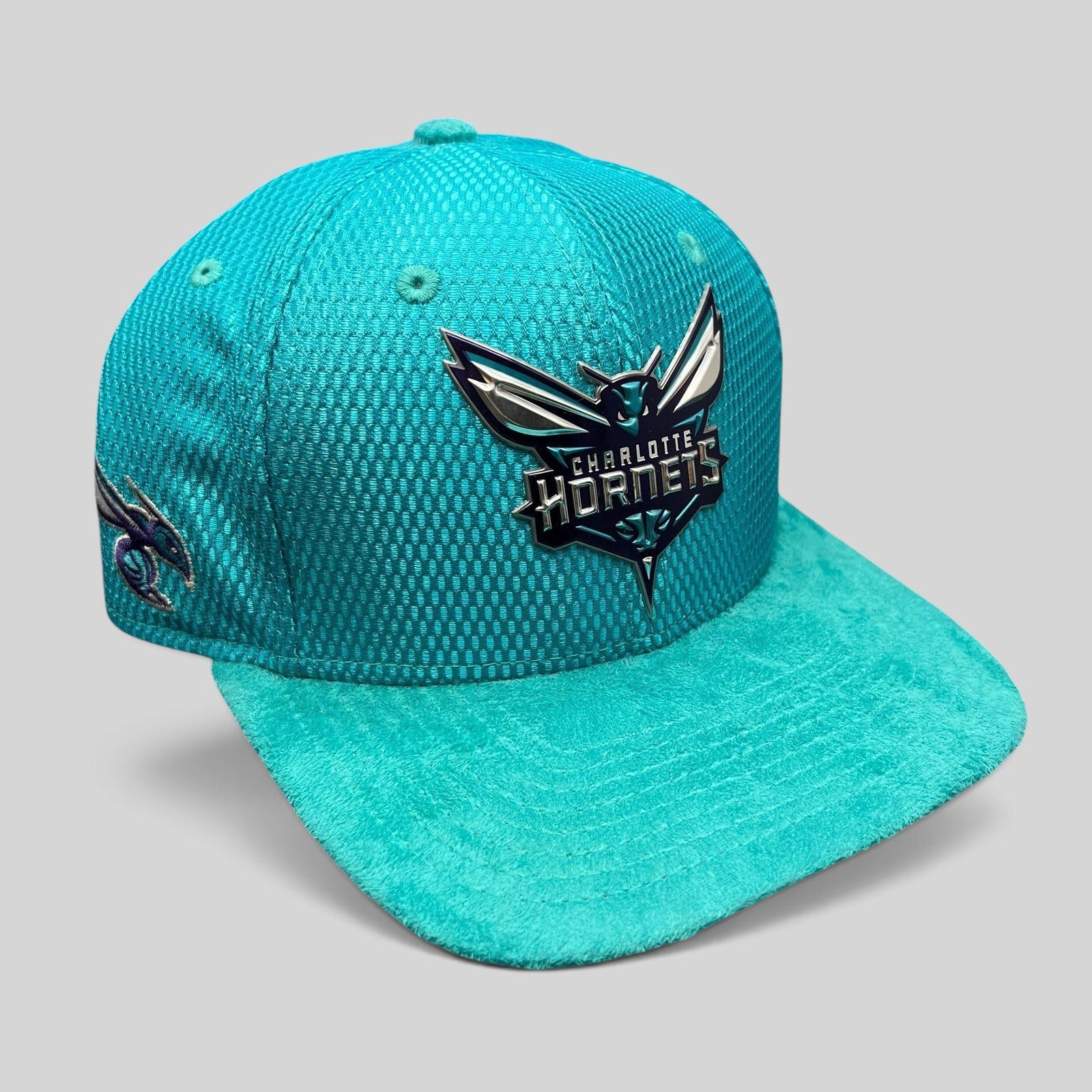 Raree Finds Charlotte Hornets New Era 9FIFTY snapback hat in teal with a raised rubberized logo and suede-style brim.
