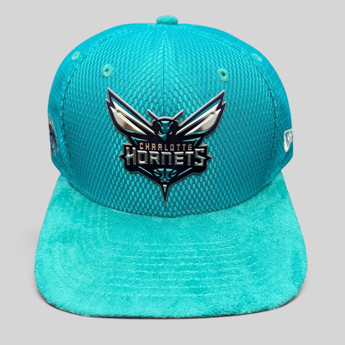 Raree Finds Charlotte Hornets New Era 9FIFTY snapback hat in teal with a raised rubberized team logo and suede brim.
