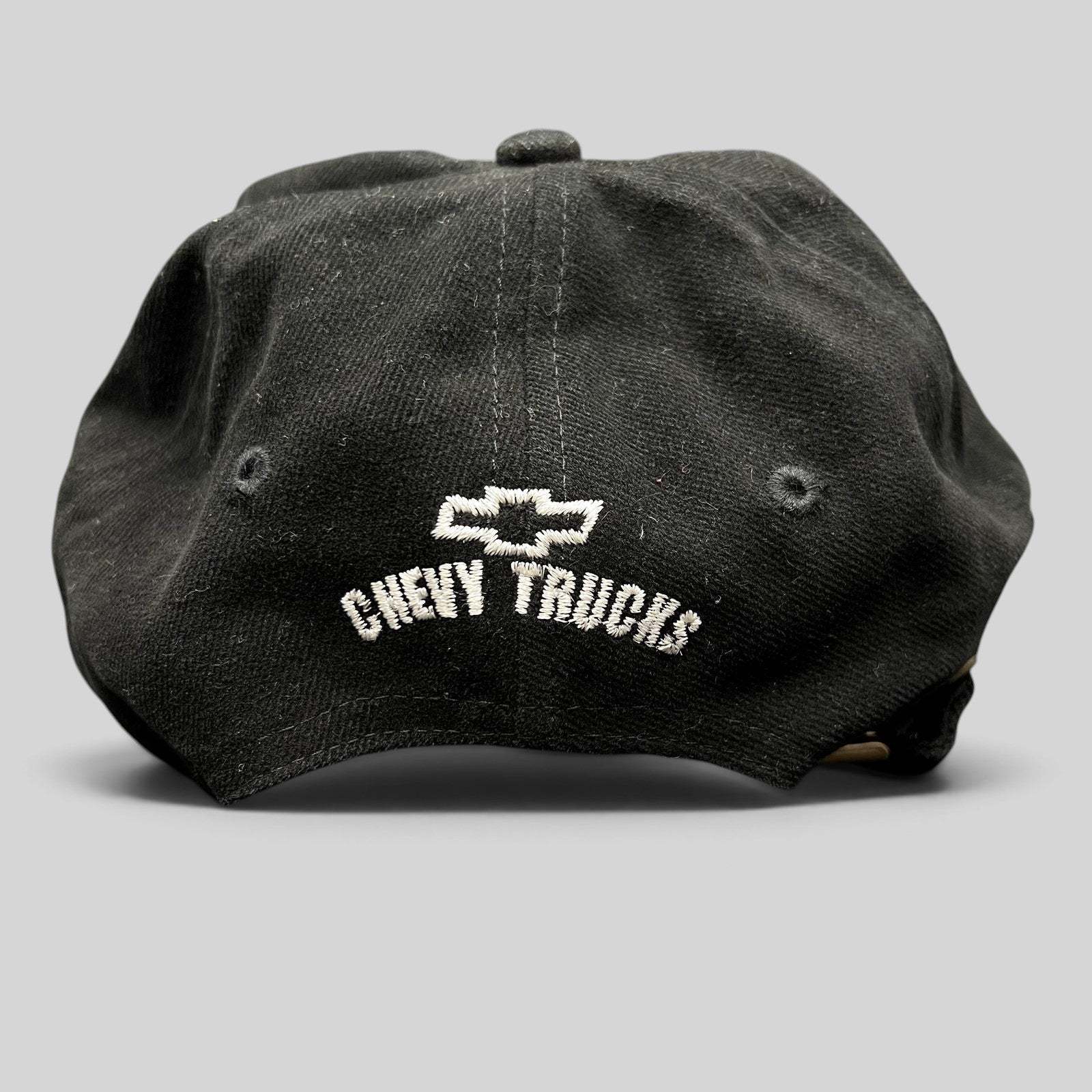 Raree Finds vintage black cotton strapback hat featuring white embroidered Chevy Trucks logo on the back panel.