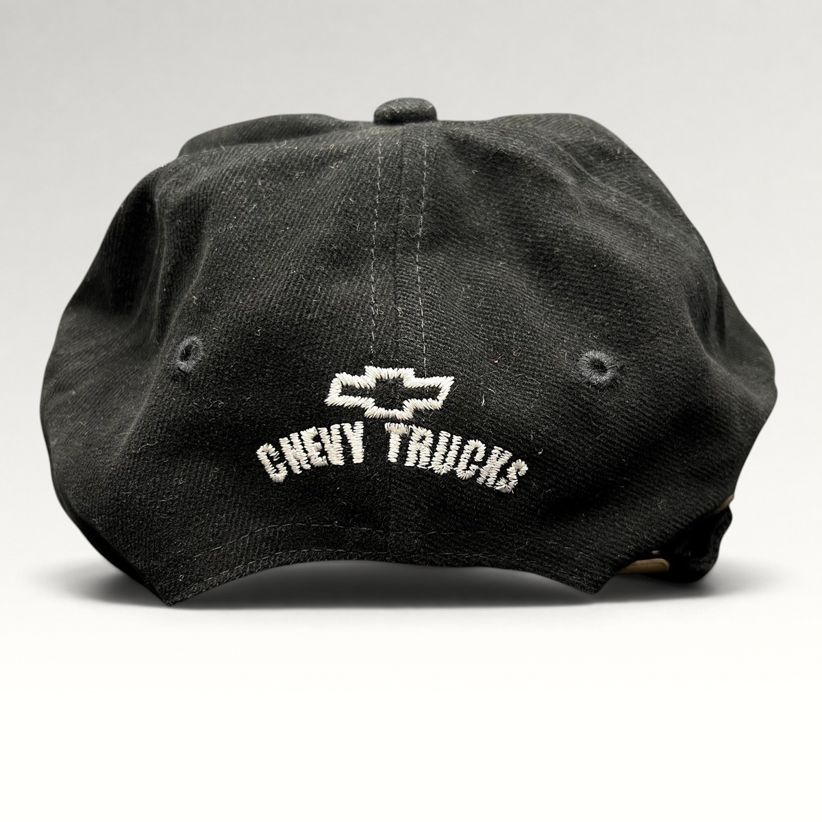 Raree Finds vintage black cotton strapback hat featuring white embroidered Chevy Trucks logo on the back panel.
