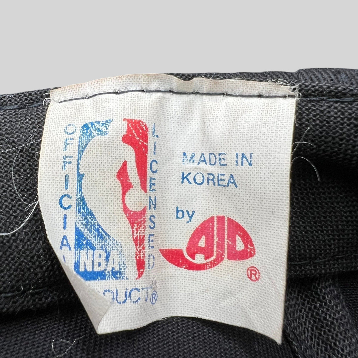 Raree Finds vintage AJD Chicago Bulls snapback hat interior tag showing NBA official product and made in Korea text