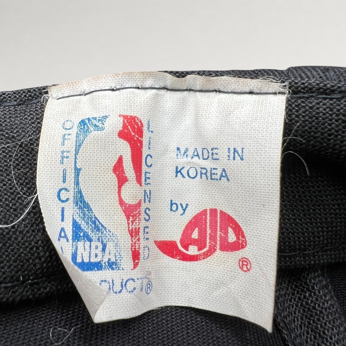 Raree Finds vintage AJD Chicago Bulls snapback hat interior tag showing NBA official product and made in Korea text