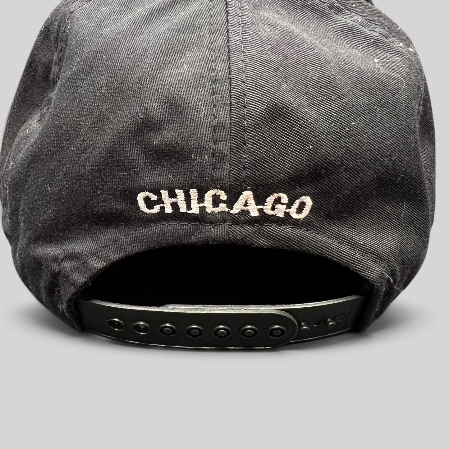 Raree Finds vintage Chicago Bulls snapback hat back view featuring white Chicago embroidery and black plastic strap
