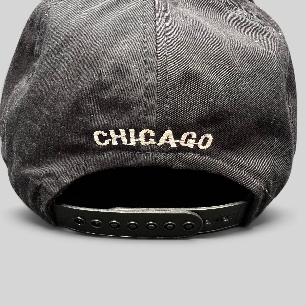 Raree Finds vintage Chicago Bulls snapback hat back view featuring white Chicago embroidery and black plastic strap