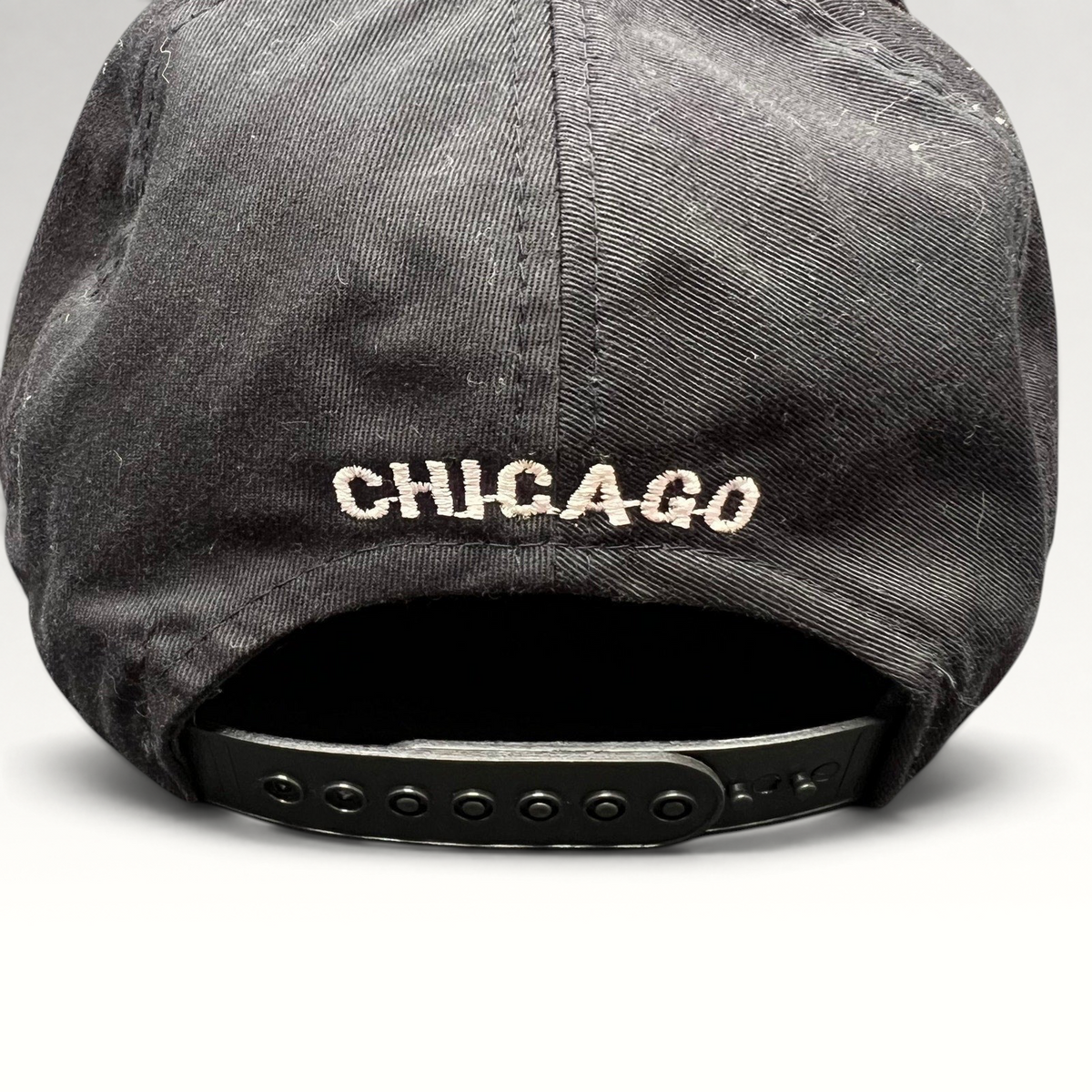 Raree Finds vintage Chicago Bulls snapback hat back view featuring white Chicago embroidery and black plastic strap