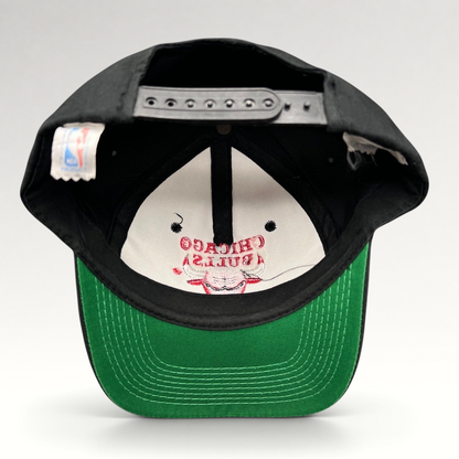 Raree Finds vintage 90s Chicago Bulls snapback hat with black crown, green under-visor, and interior NBA logo tag.