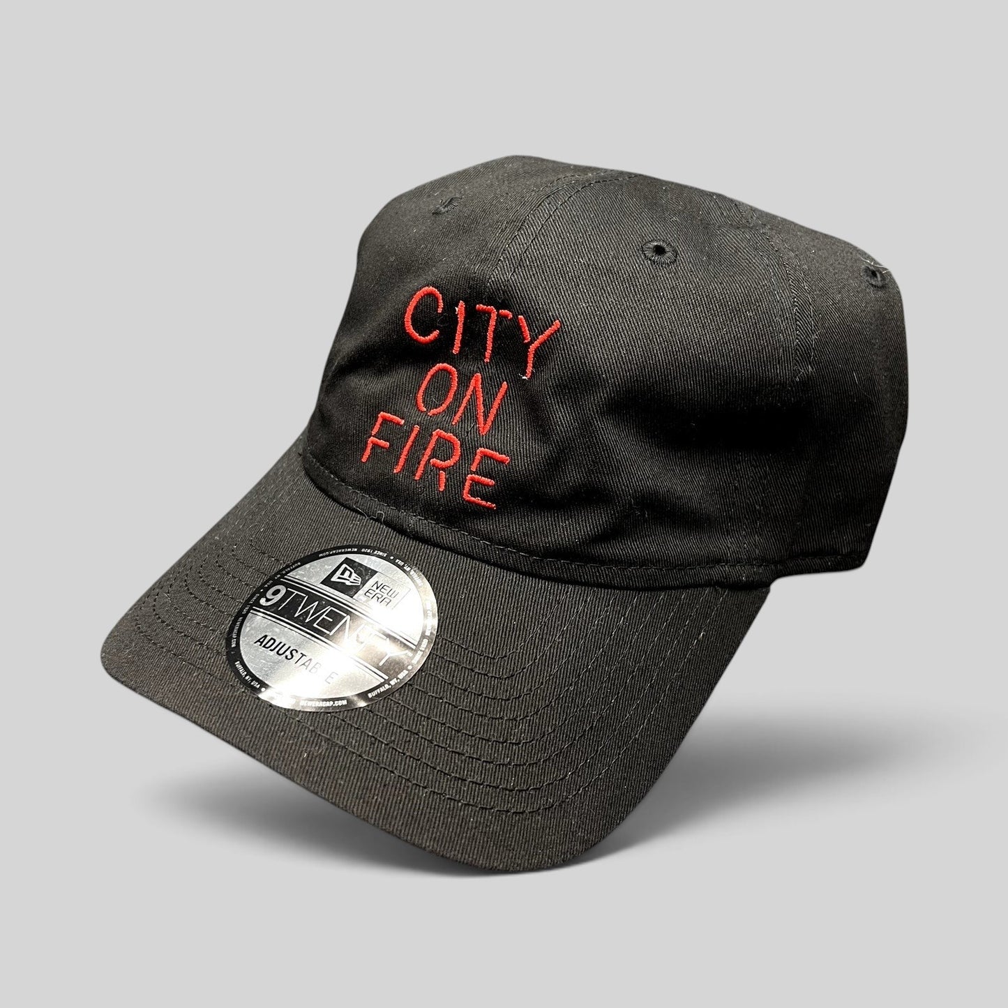 Raree Finds City On Fire black cotton New Era 9TWENTY strapback hat with red embroidered text and curved brim